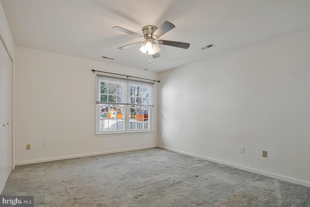 9264 Cherry Lane, Unit 47 Laurel, MD 20708 - Photo 10 of 32 an empty room with a window and a fan