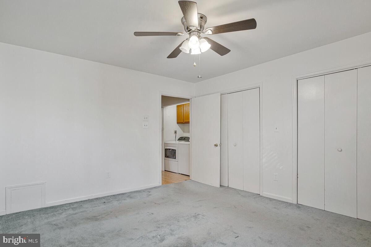 9264 Cherry Lane, Unit 47 Laurel, MD 20708 - Photo 12 of 32 an empty room with chandelier fan