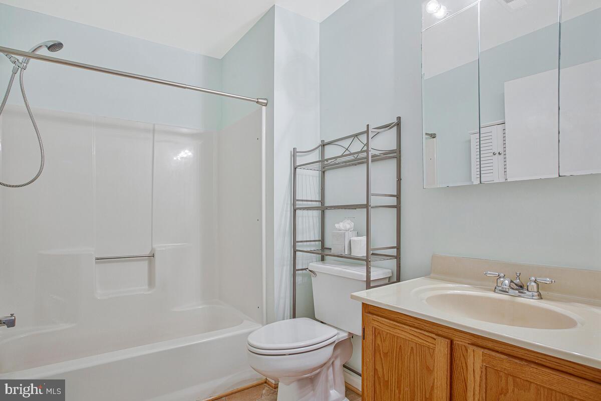 9264 Cherry Lane, Unit 47 Laurel, MD 20708 - Photo 14 of 32 a bathroom with a sink toilet vanity and shower