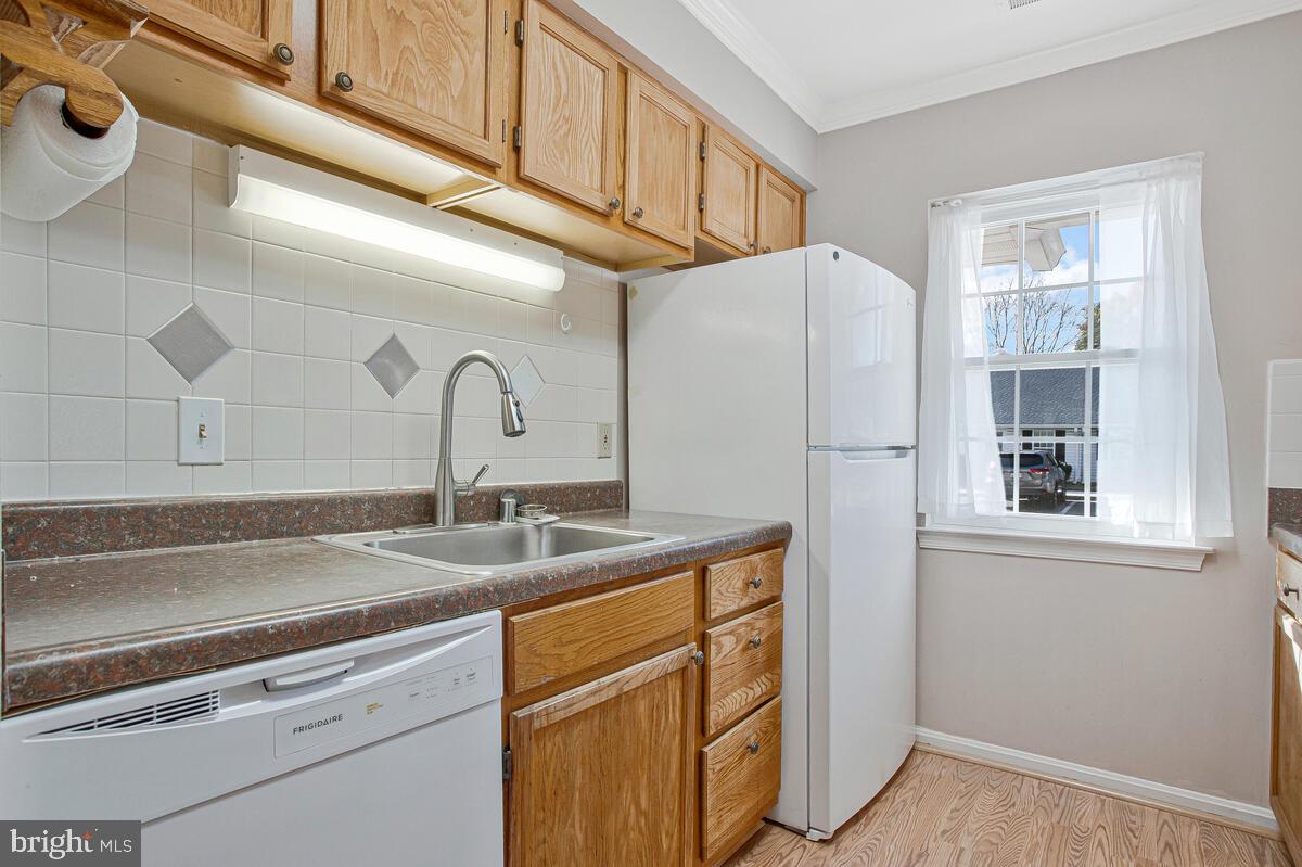9264 Cherry Lane, Unit 47 Laurel, MD 20708 - Photo 20 of 32 a kitchen with a sink cabinets and appliances