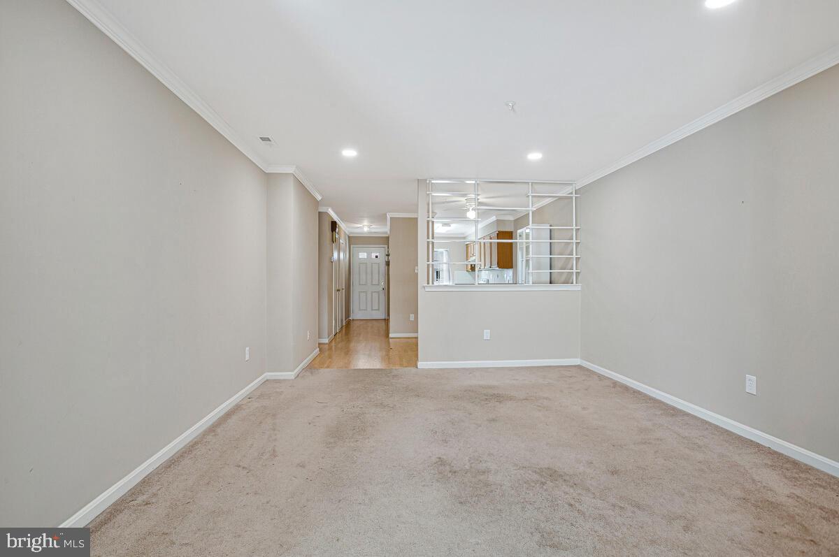 9264 Cherry Lane, Unit 47 Laurel, MD 20708 - Photo 22 of 32 a view of a big room with wooden floor and a kitchen