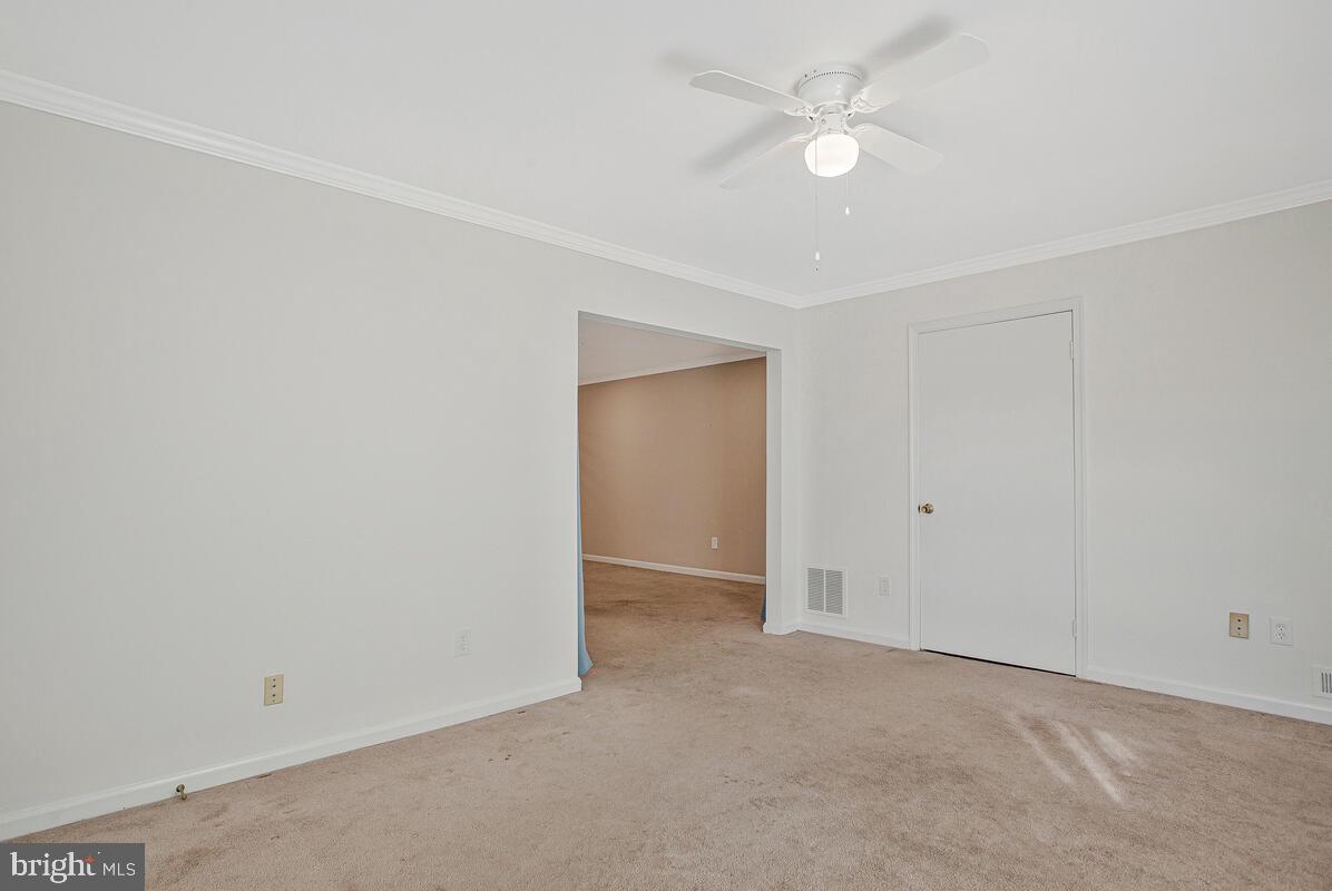 9264 Cherry Lane, Unit 47 Laurel, MD 20708 - Photo 25 of 32 an empty room with a ceiling fan and a window
