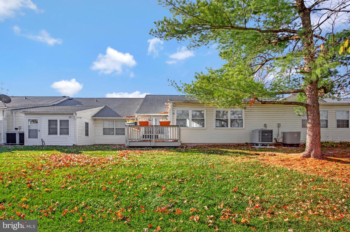 9264 Cherry Lane, Unit 47 Laurel, MD 20708 - Photo 26 of 32 a view of a house with a large tree and sitting area