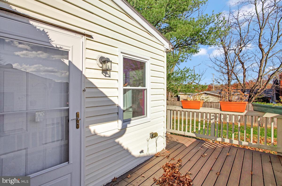 9264 Cherry Lane, Unit 47 Laurel, MD 20708 - Photo 29 of 32 a view of deck with wooden floor and fence and floor to ceiling window