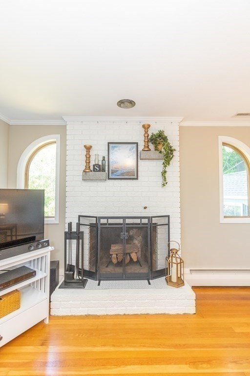 33 Keyes Road Westford, MA 01886 - Photo 11 of 42 a living room with fireplace furniture and a flat screen tv