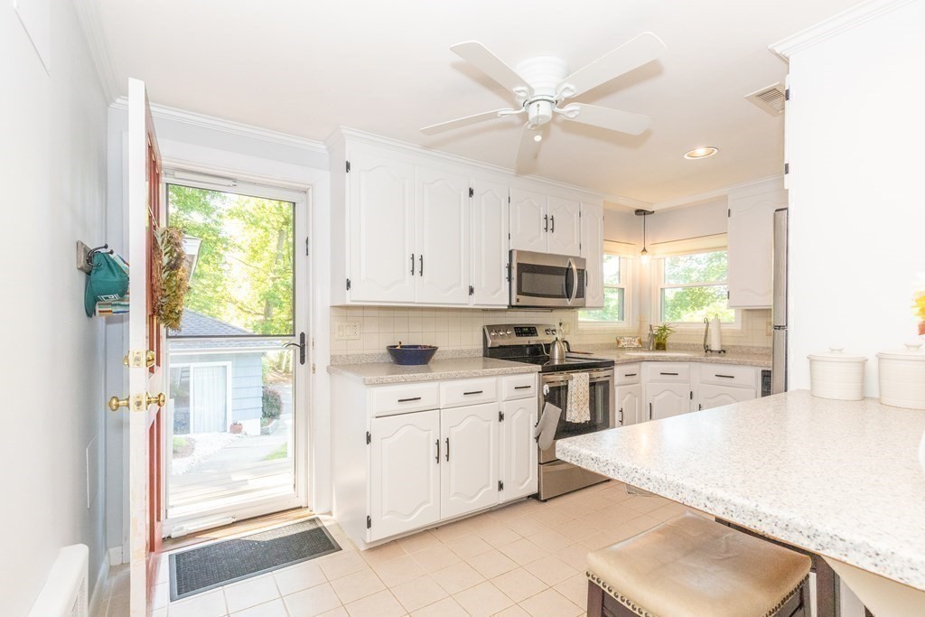 33 Keyes Road Westford, MA 01886 - Photo 15 of 42 a kitchen with a stove a sink and white cabinets