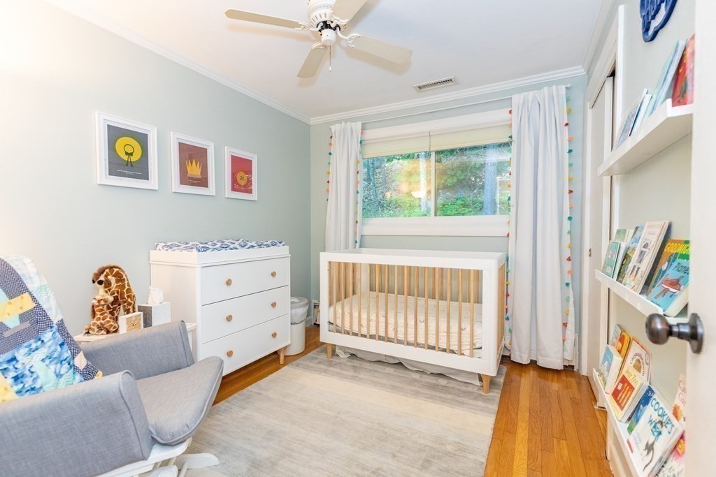 33 Keyes Road Westford, MA 01886 - Photo 24 of 42 a bedroom with a baby bed a couch and a baby crib