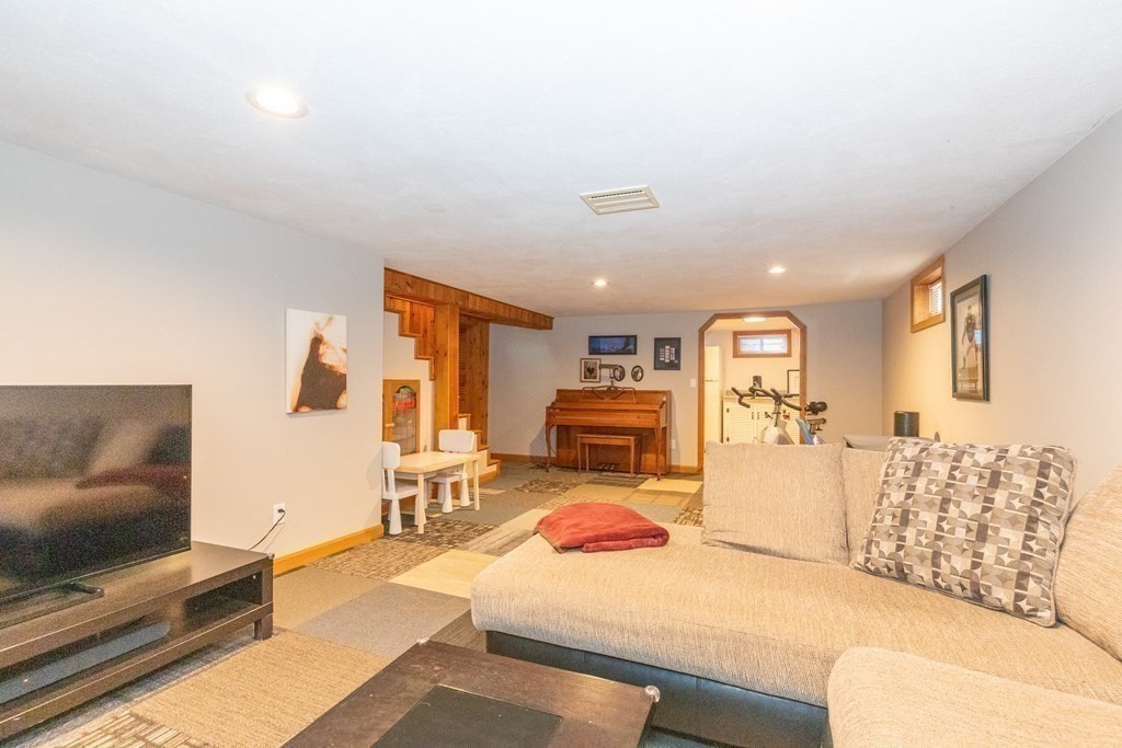 33 Keyes Road Westford, MA 01886 - Photo 27 of 42 a living room with furniture and a flat screen tv