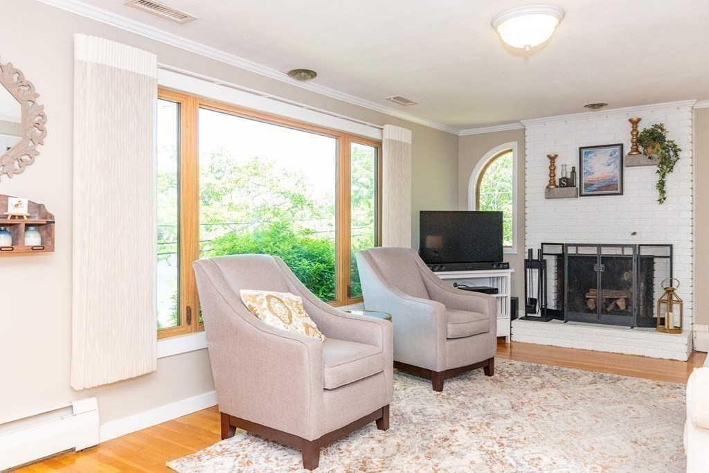 33 Keyes Road Westford, MA 01886 - Photo 10 of 42 a living room with furniture a flat screen tv and a large window