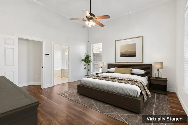 a bedroom with a large bed and a chandelier
