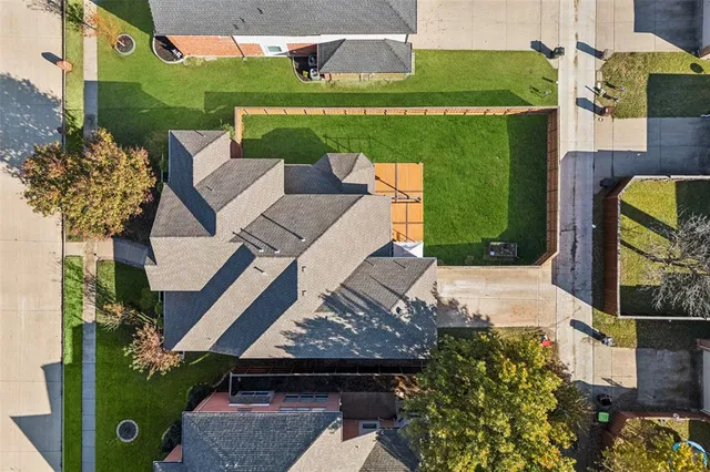 an aerial view of a house with garden space and street view
