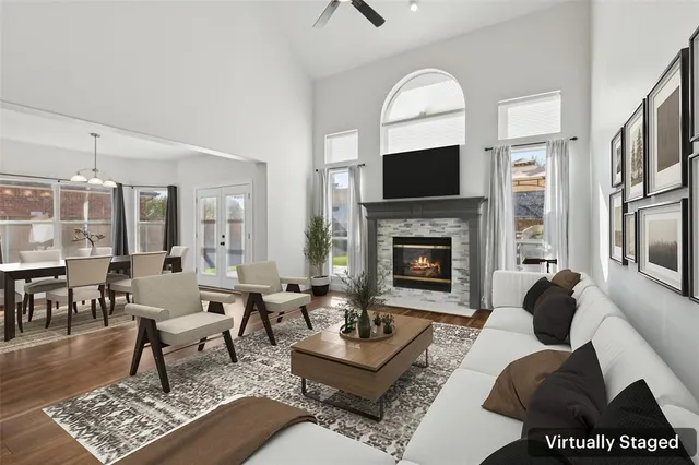 a living room with furniture a rug and a fireplace