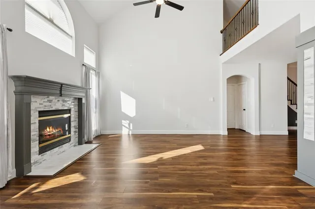a view of an empty room with window and fire place