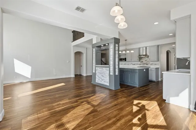 a view of kitchen with granite countertop cabinets and refrigerator