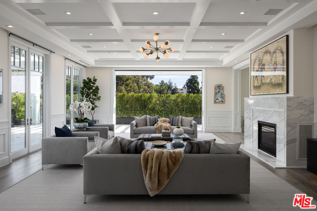 624 North Bonhill Road Los Angeles, CA 90049 - Photo 11 of 48 a living room with furniture fireplace and large windows