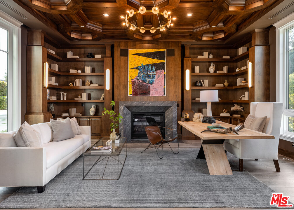 624 North Bonhill Road Los Angeles, CA 90049 - Photo 12 of 48 a living room with furniture a fireplace and a chandelier