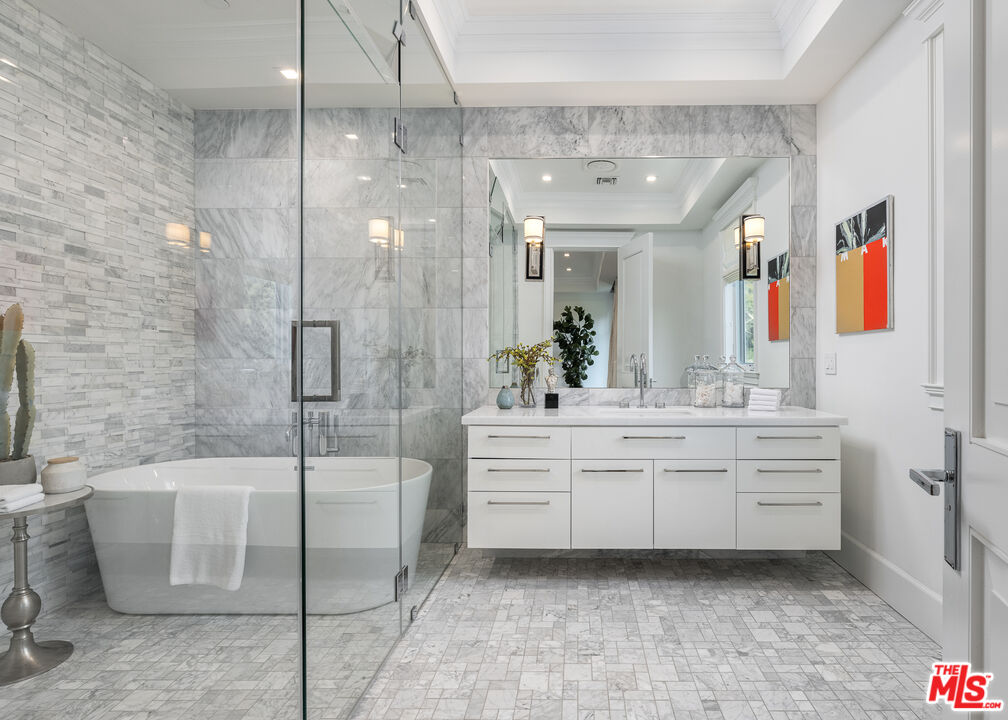 624 North Bonhill Road Los Angeles, CA 90049 - Photo 26 of 48 a bathroom with a tub a sink and glass door shower