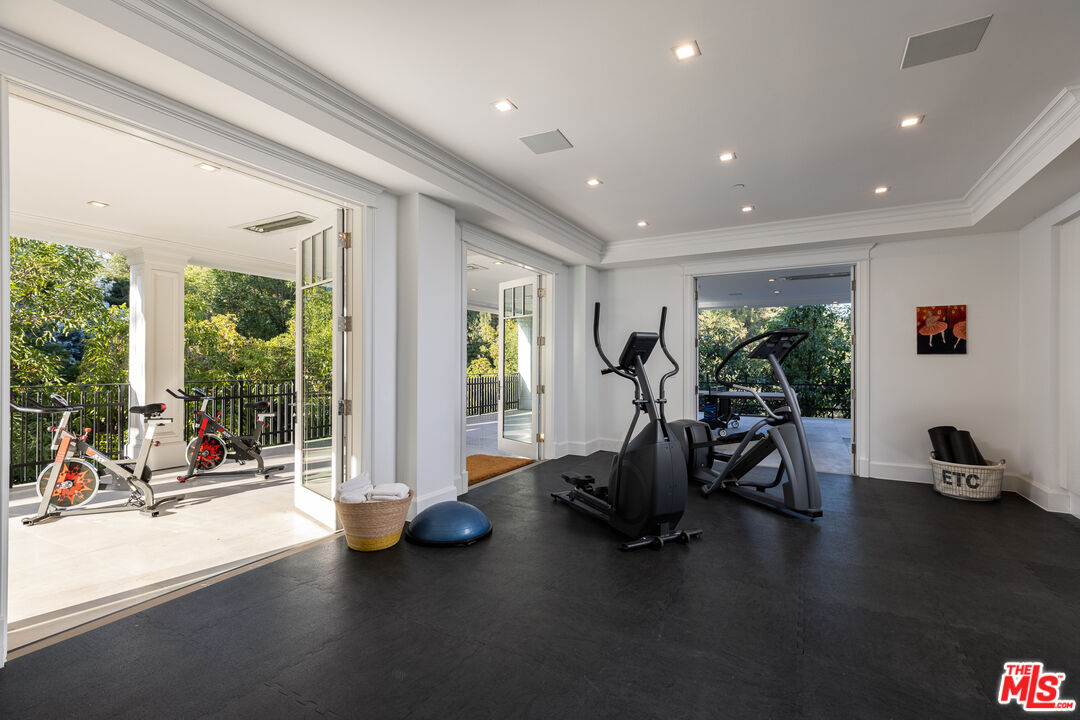624 North Bonhill Road Los Angeles, CA 90049 - Photo 33 of 48 a view of a room with gym equipment and floor to ceiling window