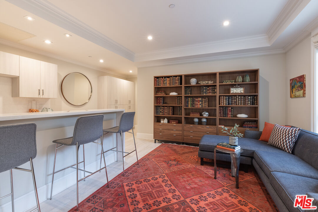 624 North Bonhill Road Los Angeles, CA 90049 - Photo 35 of 48 a living room with furniture and a book shelf