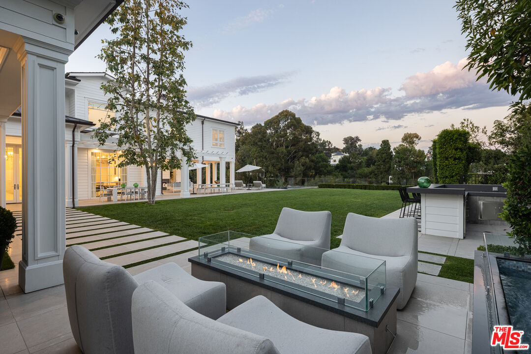 624 North Bonhill Road Los Angeles, CA 90049 - Photo 43 of 48 a view of a patio with couches potted plants and a big yard