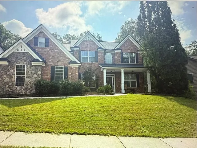 a front view of a house with a yard