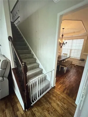 a view of entryway and hall with wooden floor