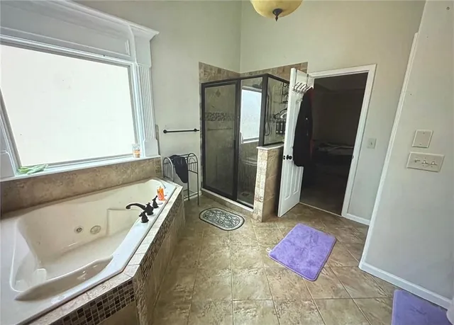 a bathroom with a tub sink and mirror