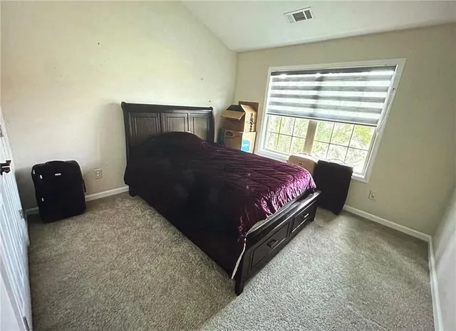 a bedroom with a bed and window