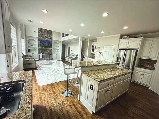 a kitchen with stainless steel appliances granite countertop a stove and a refrigerator