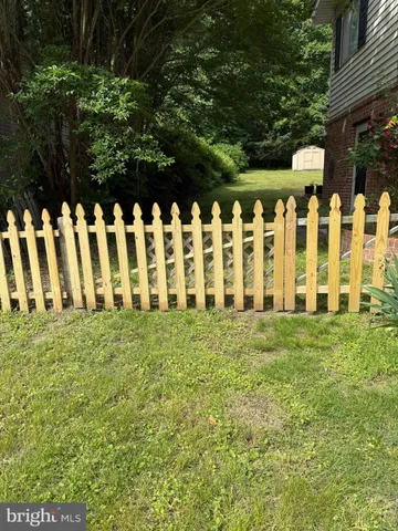 a view of yard with white fence