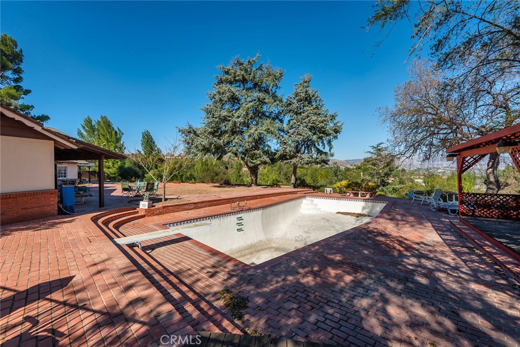 6006 Clear Valley Road Hidden Hills, CA 91302 - Photo 4 of 10 a view of a swimming pool with an outdoor seating