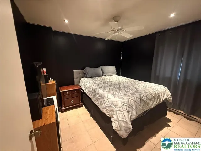 a bed sitting in a kitchen next to a window