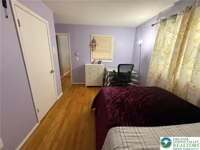 a bedroom with a bed and a mirror