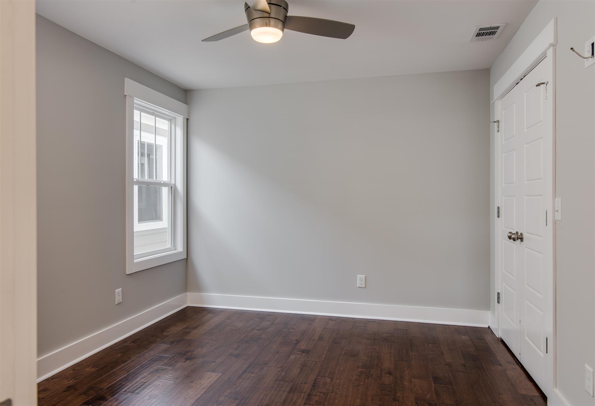 603 B Ries Avenue Nashville, TN 37209 - Photo 20 of 25 an empty room with wooden floor fan and windows