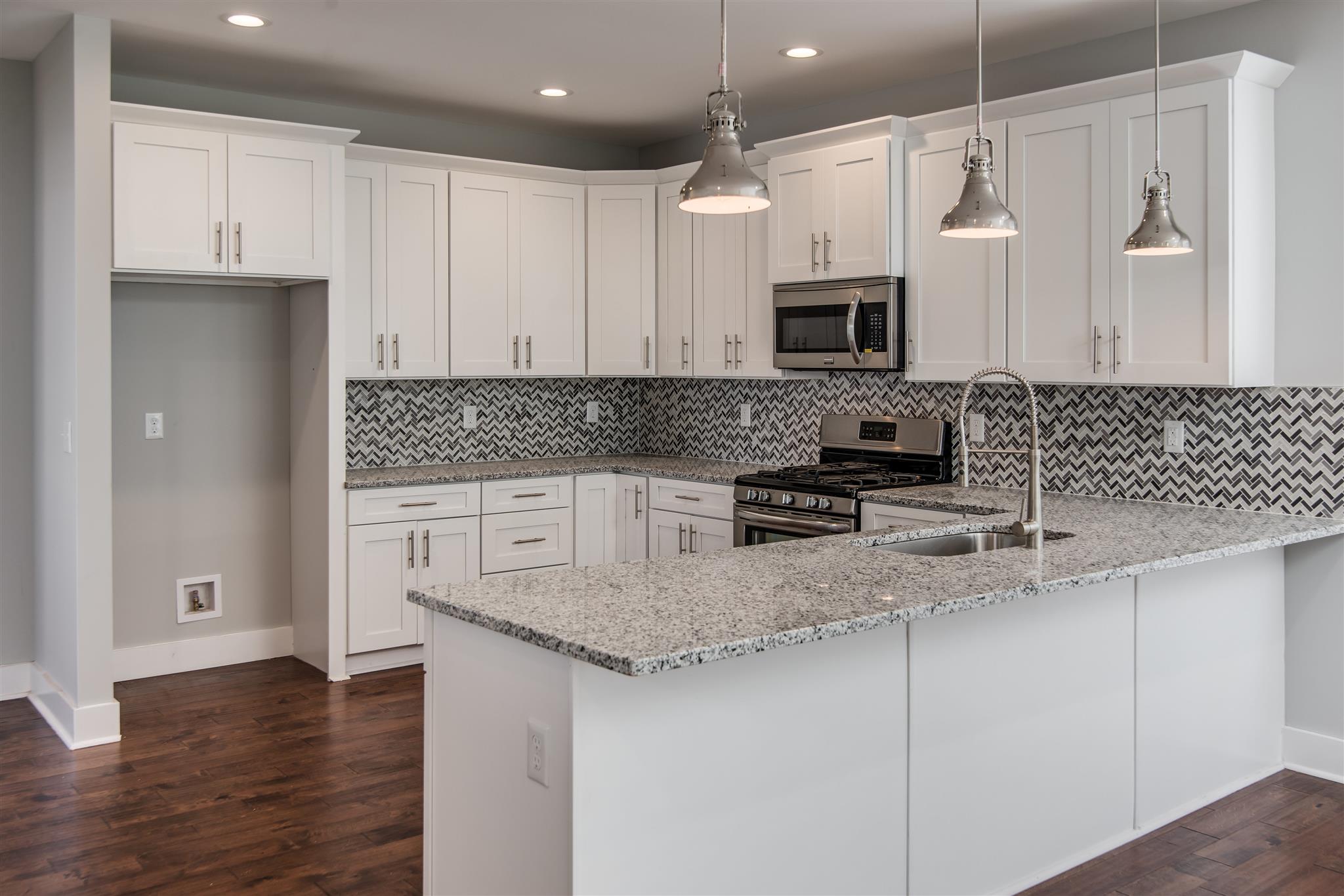 603 B Ries Avenue Nashville, TN 37209 - Photo 7 of 25 a kitchen with stainless steel appliances granite countertop a sink a stove and a refrigerator