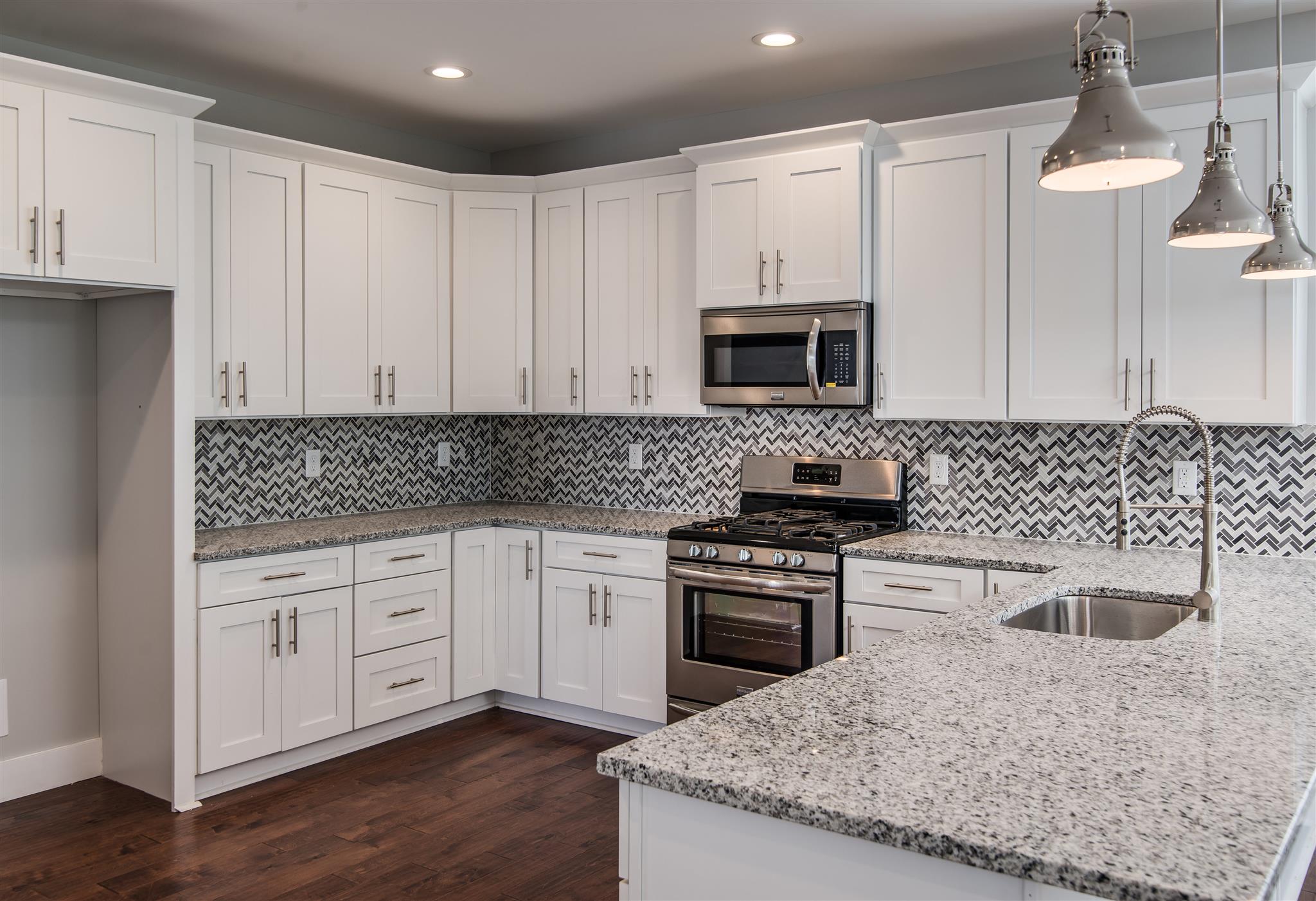 603 B Ries Avenue Nashville, TN 37209 - Photo 8 of 25 a kitchen with granite countertop white cabinets sink and stainless steel appliances