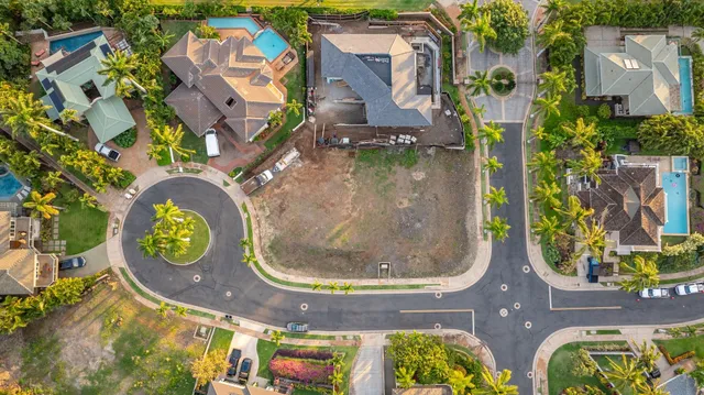 an aerial view of residential houses with outdoor space and trees
