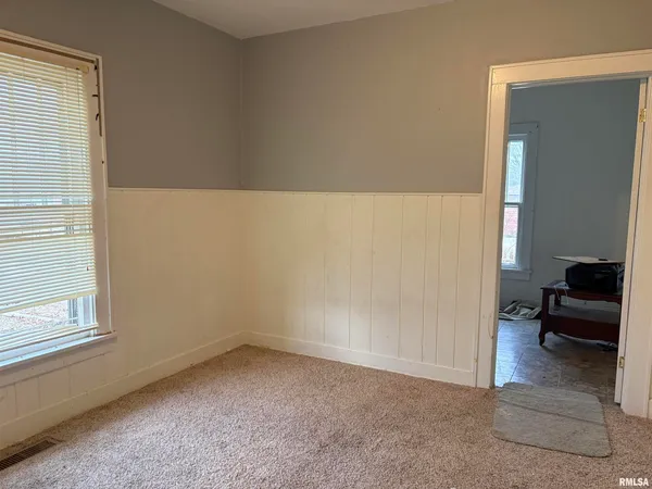 a view of an empty room and a window