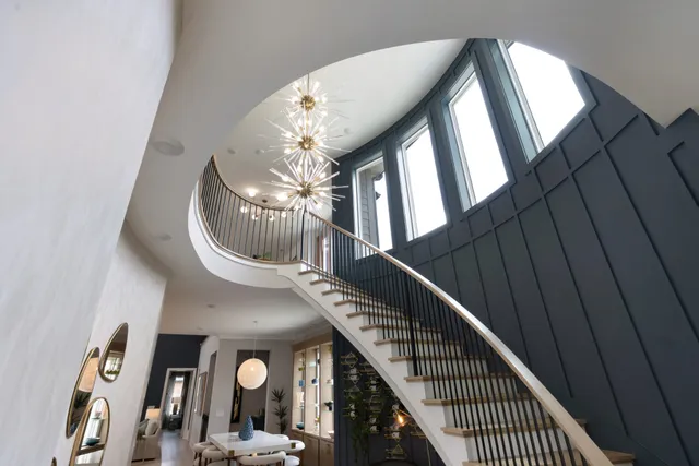 a view of a livingroom with furniture and staircase