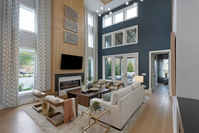 a living room with furniture wooden floor and a flat screen tv