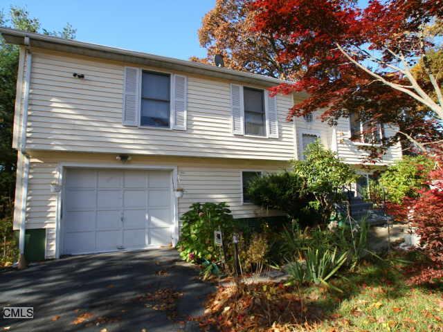 1525 Chopsey Hill Road Bridgeport, CT 06606 - Photo 1 of 1 a front view of a house with a yard