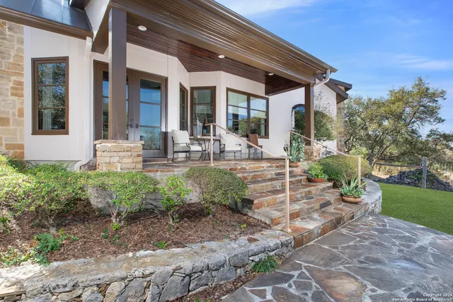 a front view of a house with garden and patio