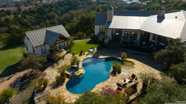 an aerial view of a house having yard swimming pool and outdoor seating