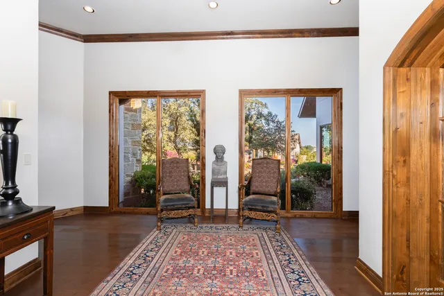 a living room with furniture a chandelier and a dining table