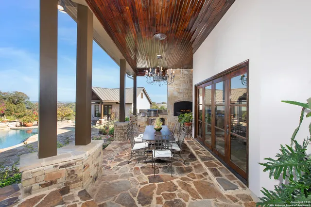 a view of a patio with chair and tables back yard of the house