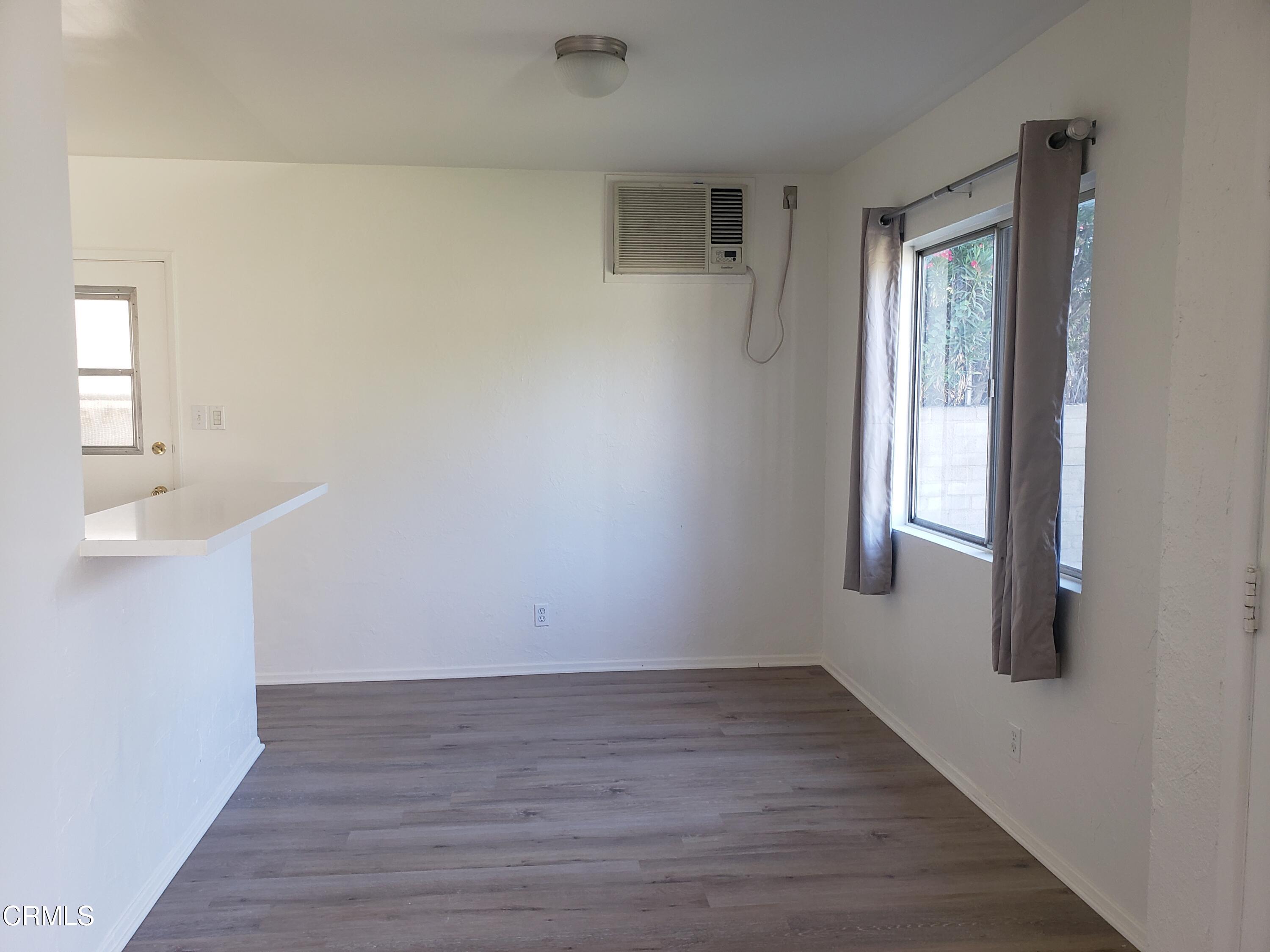 7143 Hillrose Street Tujunga, CA 91042 - Photo 13 of 13 a view of an empty room with wooden floor and a window