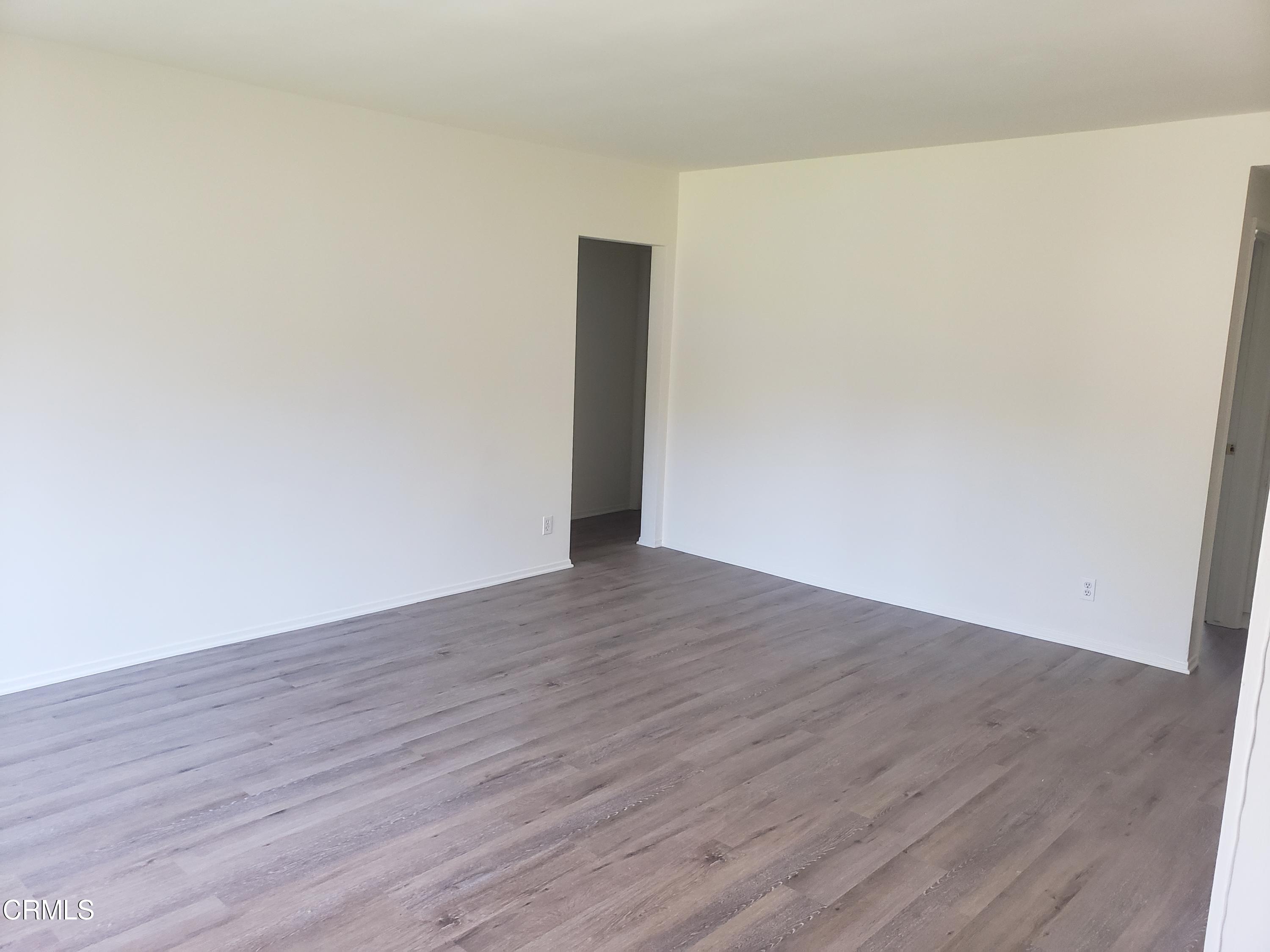 7143 Hillrose Street Tujunga, CA 91042 - Photo 3 of 13 a view of an empty room with wooden floor