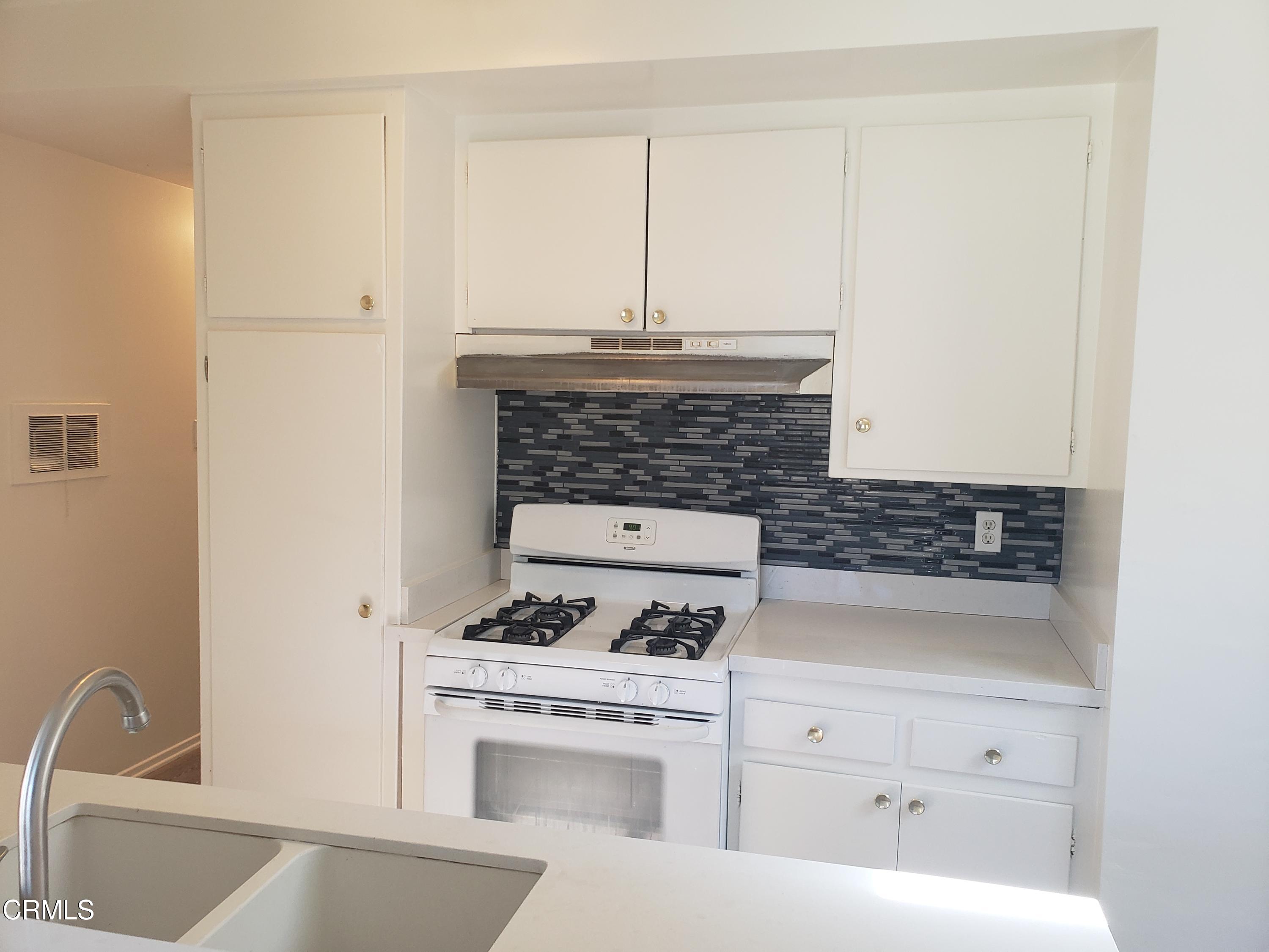 7143 Hillrose Street Tujunga, CA 91042 - Photo 5 of 13 a white stove top oven sitting inside of a kitchen