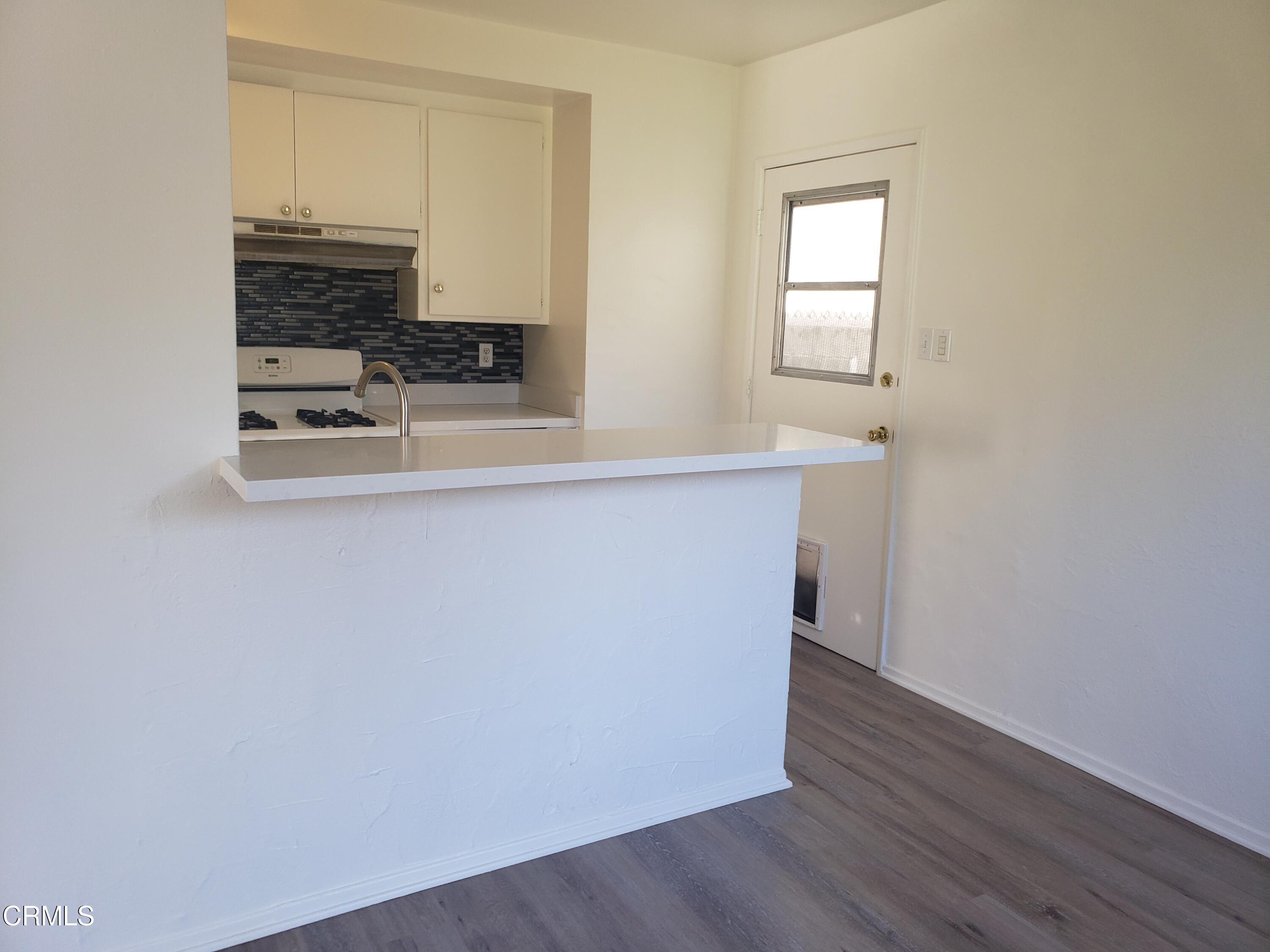 7143 Hillrose Street Tujunga, CA 91042 - Photo 7 of 13 a view of a kitchen with wooden floor