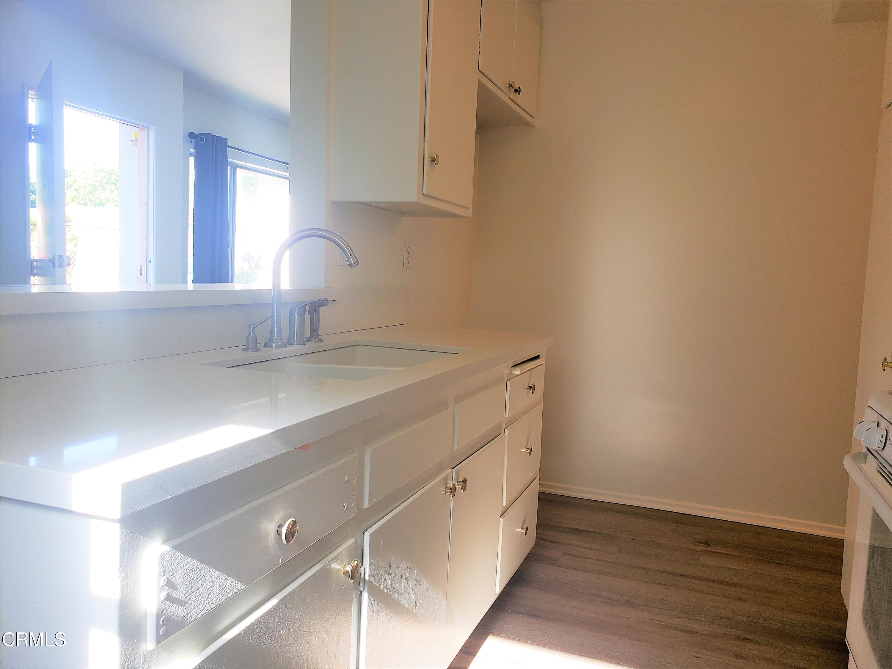 7143 Hillrose Street Tujunga, CA 91042 - Photo 8 of 13 a room with a sink cabinets and a window